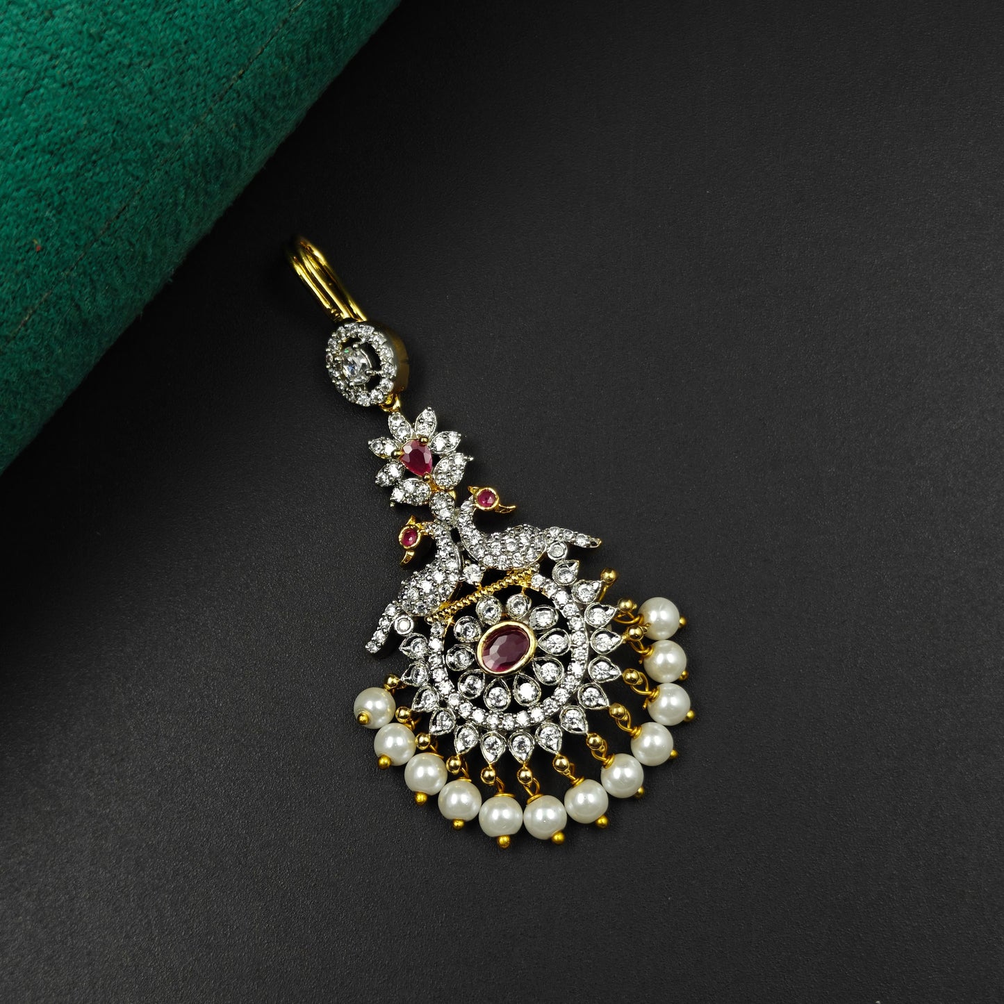 33384 Peacock design maangtikka with red stones, white CZ crystals, and pearl drops