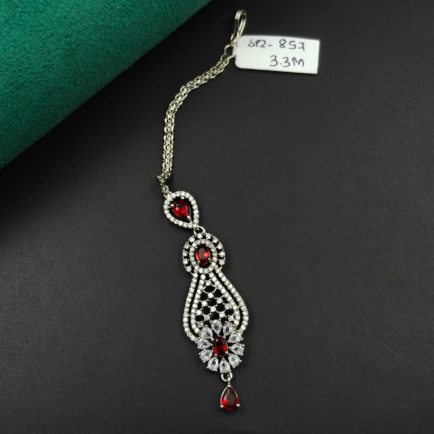 857 Elongated teardrop design maangtikka with red stones and white CZ crystals