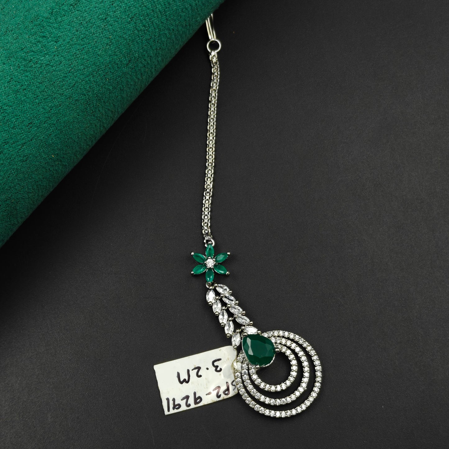 9291 Floral and circular design maangtikka with green stones and white CZ crystals