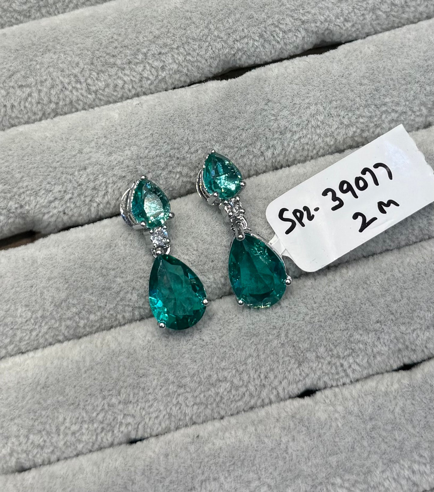39077 Platinum earrings with peacock green stone