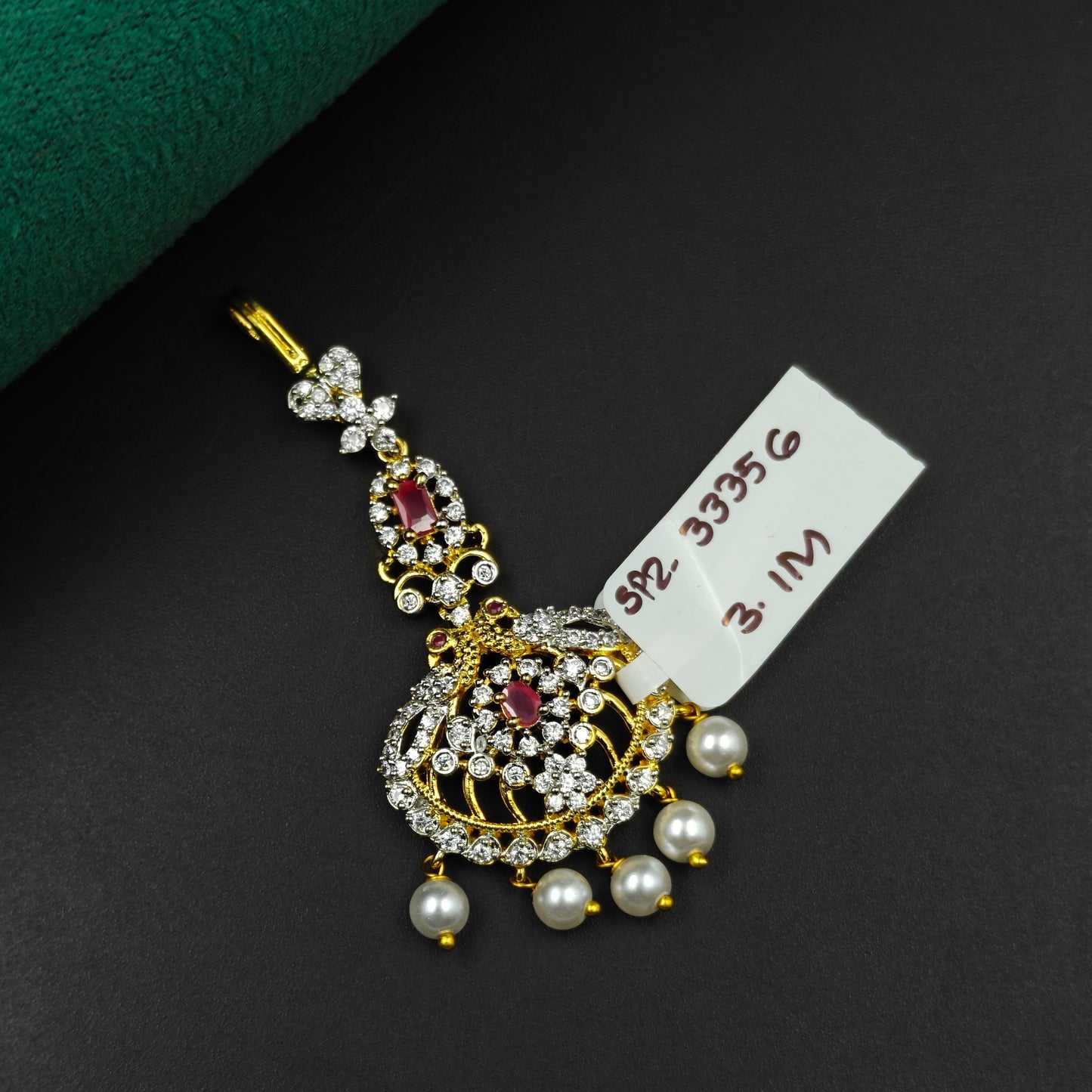 33356 Round design maangtikka with red stones, white CZ crystals, and pearl drops