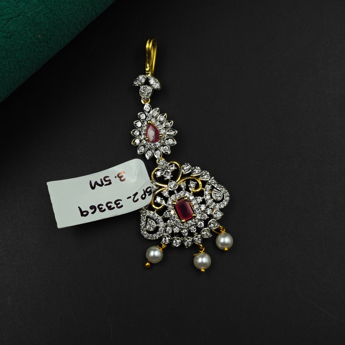 33369 Floral design maangtikka with red stones, white CZ crystals, and pearl drops
