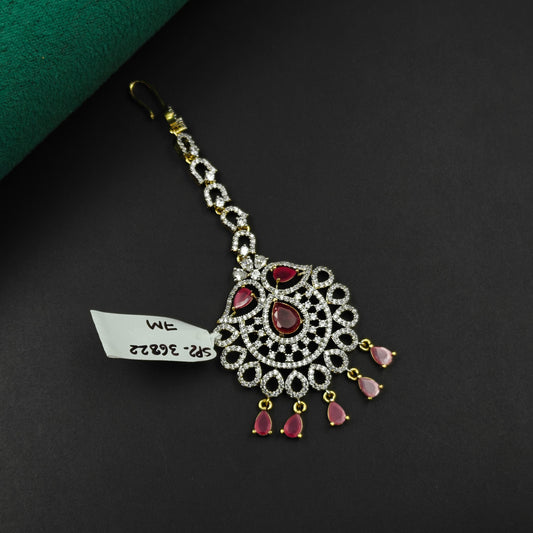 36822 Oval design maangtikka with red stones and white CZ crystals