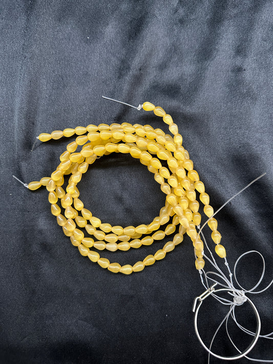 Yellow tear drop beads per line