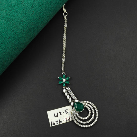 9291 Floral and circular design maangtikka with green stones and white CZ crystals
