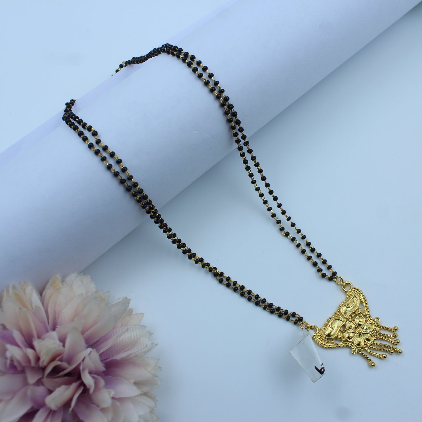 14229 Traditional gold mangalsutra with black beads and  floral pendant design