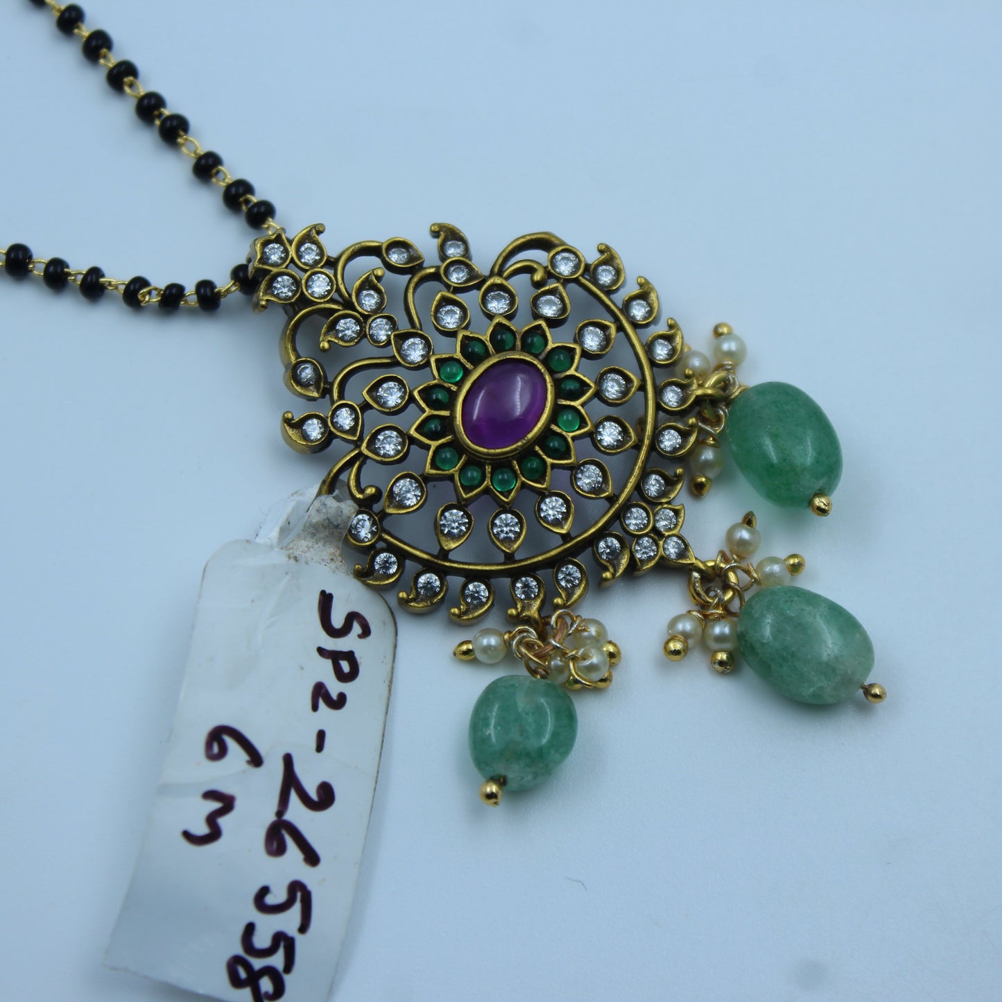 26558  Black Bead Mangalsutra with Green Beads and Pink Stone Pendant