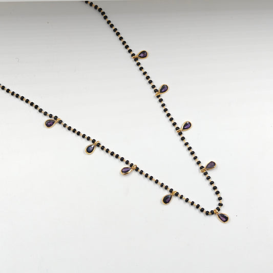 Black beads with drop pattern in purple