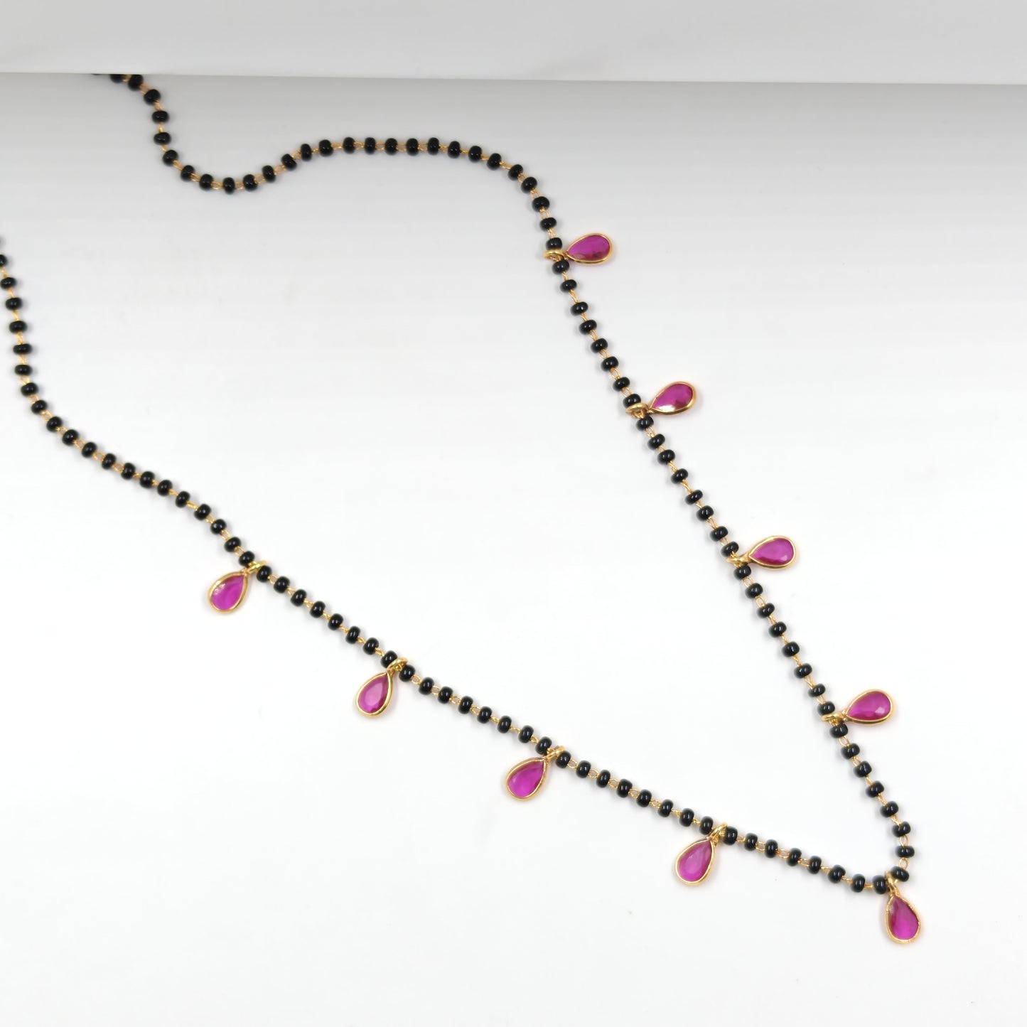Black beads with drop pattern in red