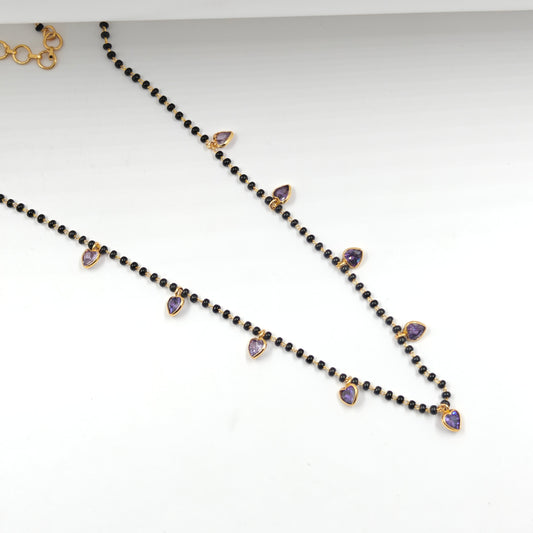 Black beads with drop and heart pattern in purple