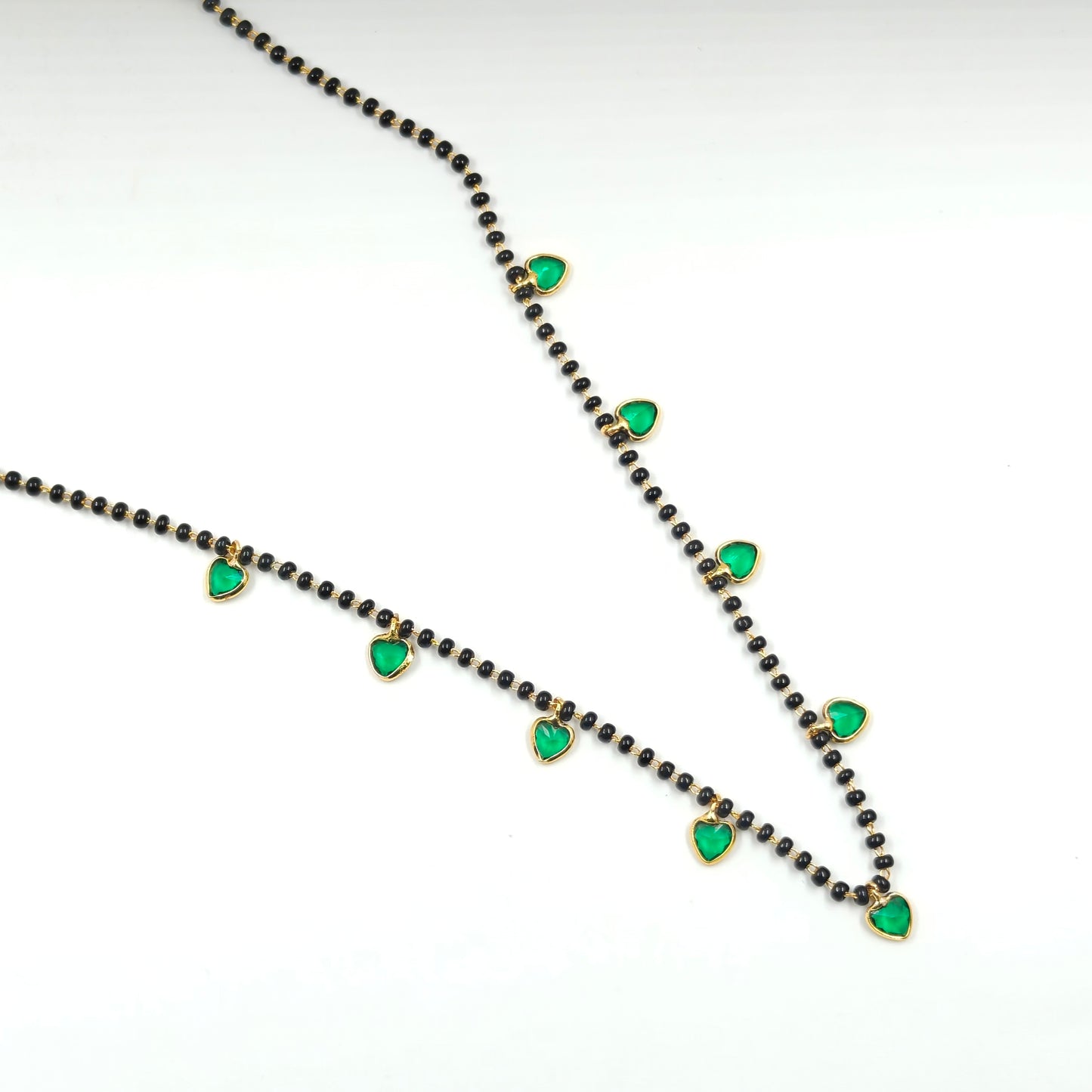 Black beads with drop and heart pattern in green